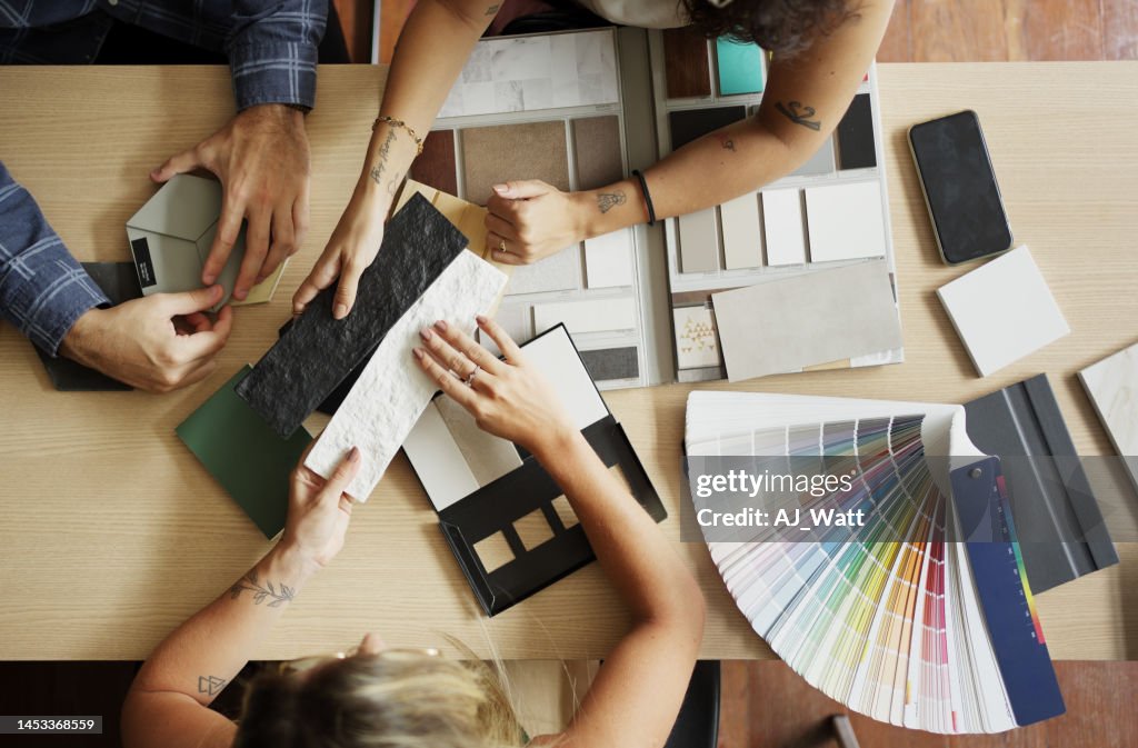 Interior designer discussing tile and color options with clients in her office