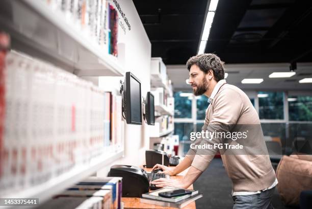 Person Using Computer At A Library Public Library Bookshelf Photos and Premium High Res Pictures - Getty ...
