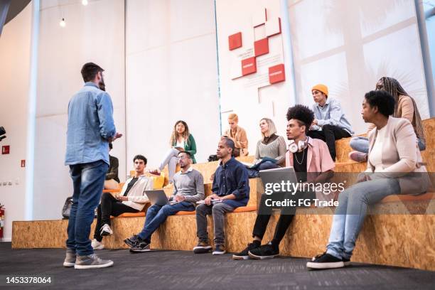 man giving lecture to students at the university - business school campus stock pictures, royalty-free photos & images