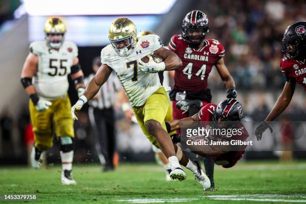 Audric Estime of the Notre Dame Fighting Irish runs the ball against Nick Emmanwori of the South Carolina Gamecocks during the second half of the...