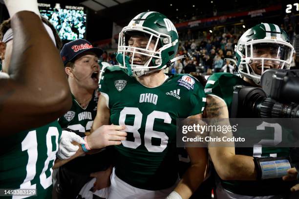 Tight end Tyler Foster of the Ohio Bobcats celebrates with teammates after scoring the game winning touchdown in overtime of the Barstool Sports...