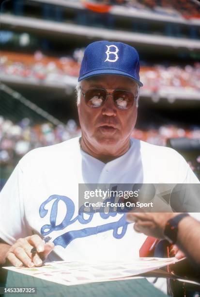 Former Brooklyn/Los Angeles Dodger Duke Snider signs autographs prior to the start of an Old Timers Game before a Major League Baseball game circa...