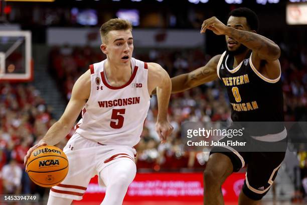 Tyler Wahl of the Wisconsin Badgers drives against Markeese Hastings of the Western Michigan Broncos during the second half at Kohl Center on...