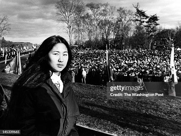 Maya Lin, architect of the Vietnam Memorial stands during the dedication on November 13, 1982. A large crowd of friends and relatives of those who...