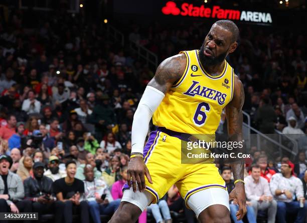 LeBron James of the Los Angeles Lakers reacts after dunking against Onyeka Okongwu of the Atlanta Hawks during the fourth quarter at State Farm Arena...