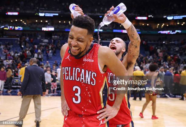 McCollum is dunked with water by Jose Alvarado of the New Orleans Pelicans after a game against the Philadelphia 76ers at the Smoothie King Center on...