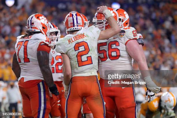 Cade Klubnik of the Clemson Tigers celebrates with his teammates after scoring a touchdown against the Tennessee Volunteers during the fourth quarter...