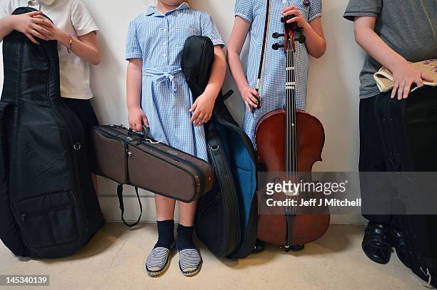 Children from the Big Noise Orchestra wait to enter for rehearsals for The Big Concert, to be held on the Raploch Estate, on May 24, 2012 in...