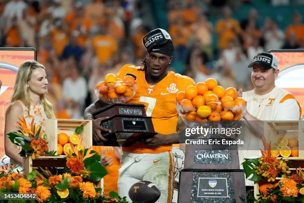 Joe Milton III of the Tennessee Volunteers celebrates with the MVP trophy on stage after defeating the Clemson Tigers in the Capital One Orange Bowl...