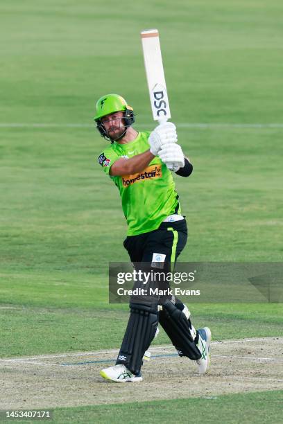 Alex Hales of the Thunder hits a six on to the roof of the grandstand during the Men's Big Bash League match between the Sydney Thunder and the...