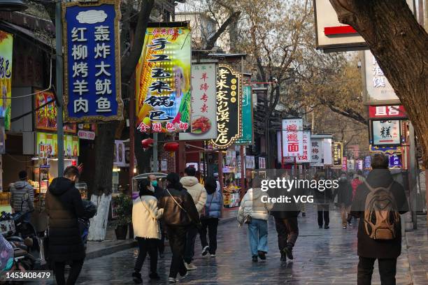 Tourists visit the Muslim Quarter, a very famous snack and commercial street in China, ahead of Chinese New Year, the Year of the Rabbit, on December...