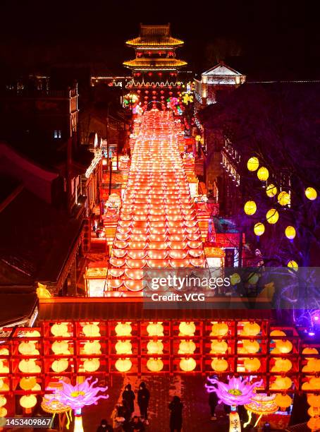 Tourists visit a lantern show as a part of 2023 Shenyang International Ice and Snow Festival at Guandong Movie and TV Town ahead of Chinese New Year,...