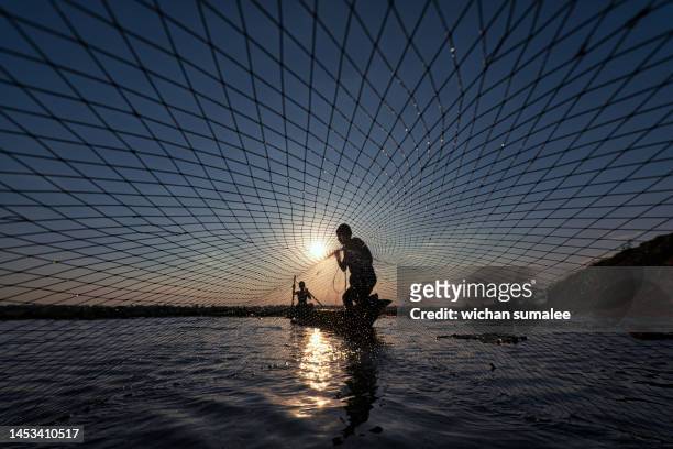 fishing with nets - commercial fishing net fotografías e imágenes de stock