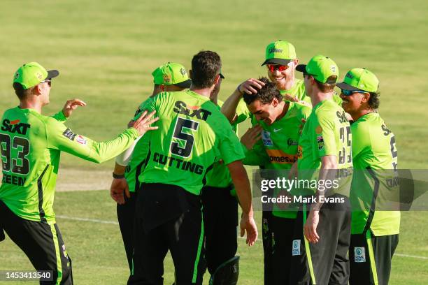 The Thunder celebrate the run out of Tim David of the Hurricanes during the Men's Big Bash League match between the Sydney Thunder and the Hobart...