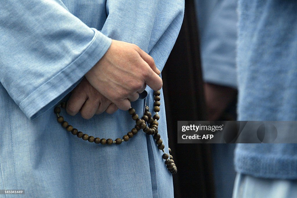 Nuns react as black smoke rises from the