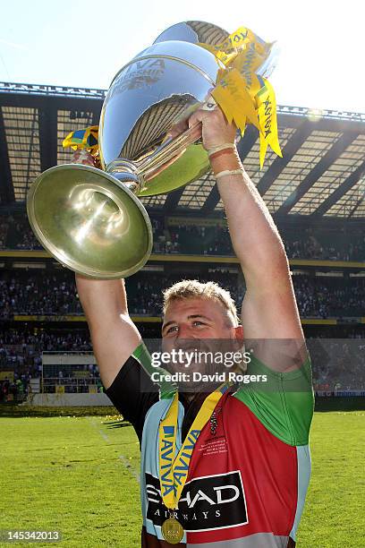 Joe Marler of Harlequins celebrates with the trophy following his team's victory during the Aviva Premiership final between Harlequins and Leicester...