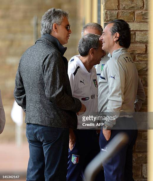 Italian singer Andrea Bocelli arrives with Italian coach Cesare Prandelli for a national football team training session in Firenze on May 27, 2012....