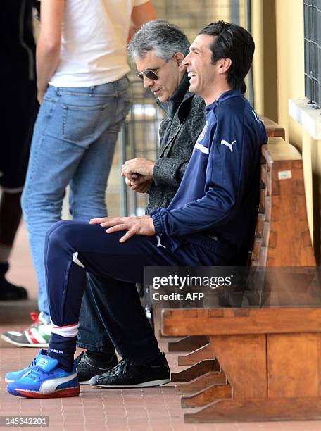 Italian singer Andrea Bocelli sits with Italian player GianLuigi Buffon during a national football team training session in Firenze on May 27, 2012....