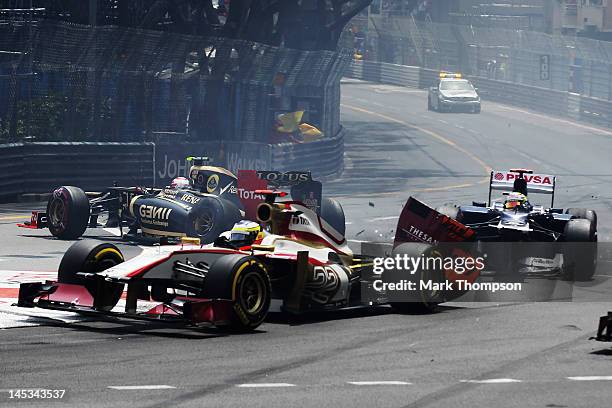 Pastor Maldonado of Venezuela and Williams collides with Pedro de la Rosa of Spain and Hispania Racing Team at the first corner, while in the...