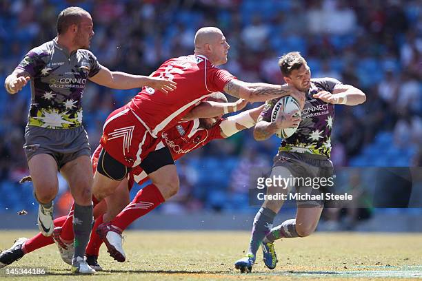 Danny Brough of Huddersfield Giants is halted by Lee Jewitt and Adam Sidlow of Salford City Reds during the Stobart Super League 'Magic Weekend'...