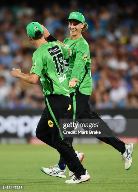 Trent Boult of the Stars celebrates after catching the wicket of Colin De Grandhomme of the Strikers with Campbell Kellaway of the Stars during the...