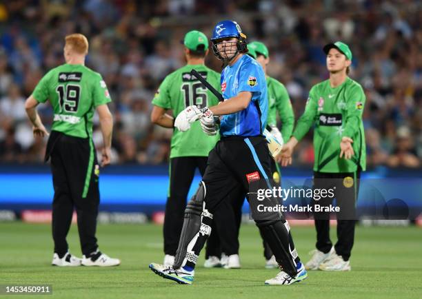 Thomas Kelly of the Strikers leaves the ground after getting out to Liam Hatcher of the Stars during the Men's Big Bash League match between the...