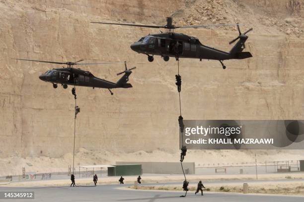 Jordanian and US special forces conduct fast-roping from a Black Hawk helicopter at the King Abdullah Special Operations Training Centre in Amman on...
