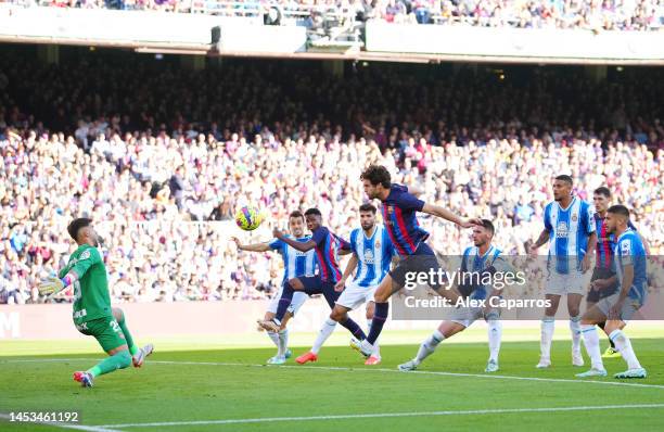 Marcos Alonso of FC Barcelona has a shot on goal as Alvaro Fernandez of RCD Espanyol attempts to make a save during the LaLiga Santander match...