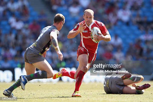 Daniel Holdsworth of Salford City Reds holds off Kevin Brown of Huddersfield Giants during the Stobart Super League 'Magic Weekend' match between...