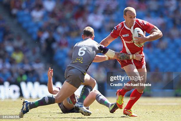 Daniel Holdsworth of Salford City Reds holds off Kevin Brown of Huddersfield Giants during the Stobart Super League 'Magic Weekend' match between...