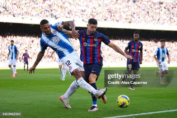 Vinicius Souza of RCD Espanyol is challenged by Robert Lewandowski of FC Barcelona during the LaLiga Santander match between FC Barcelona and RCD...