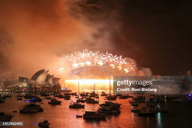 Fireworks light up the sky over Sydney Harbour Bridge during New Year's Eve celebration on January 01, 2023 in Sydney, Australia. Revelers turned out...