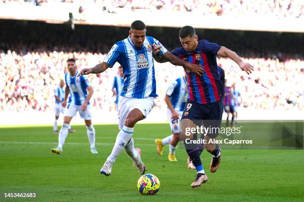 Vinicius Souza of RCD Espanyol is challenged by Robert Lewandowski of FC Barcelonaduring the LaLiga Santander match between FC Barcelona and RCD...