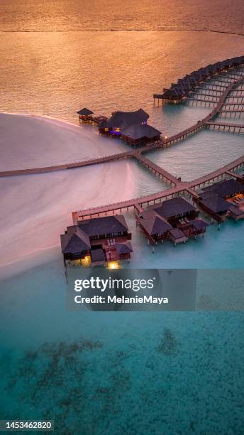 maldives island resort in sunset with view over horizon drone view - luxury hotel island stock pictures, royalty-free photos & images