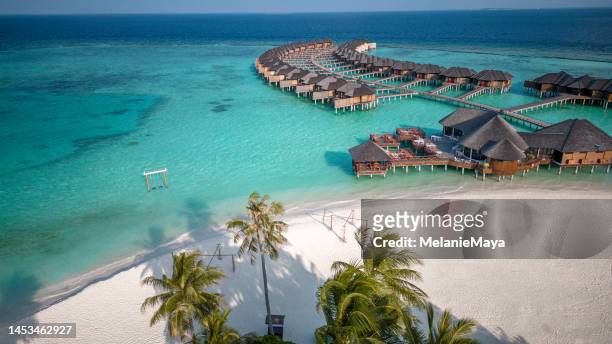 maldives hotel beach resort on tropical island with aerial drone view - malediven stockfoto's en -beelden