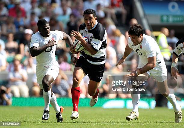 Mils Muliaina of The Barbarians splits the England defence during the Killik Cup match between England and The Barbarians at Twickenham Stadium on...