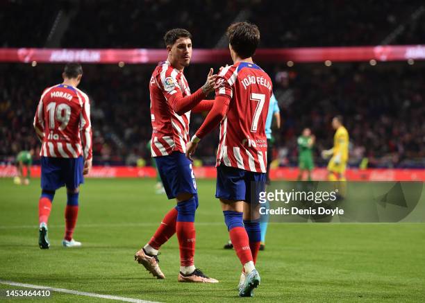 Joao Felix of Atletico Madrid celebrates with teammate Jose Maria Gimenez after scoring their sides first goal during the LaLiga Santander match...