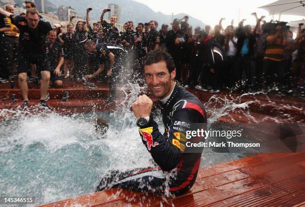 Mark Webber of Australia and Red Bull Racing celebrates winning the race by jumping into the swimming pool on the Red Bull Energy Station following...