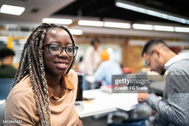 portrait of a young student woman in the university classroom - braided hairstyles for african american girls stock pictures, royalty-free photos & images