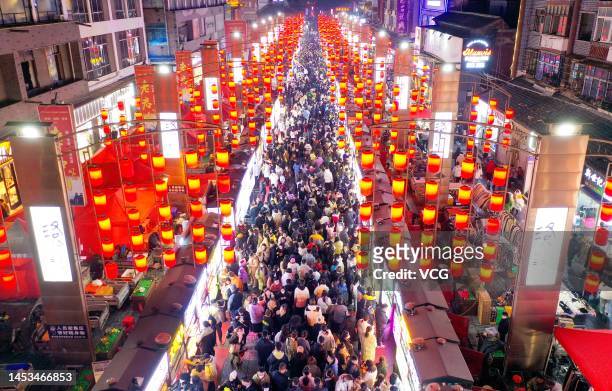 Tourists visit Shizi Street night market on the first day of New Year's Day holiday on December 31, 2022 in Luoyang, Henan Province of China.