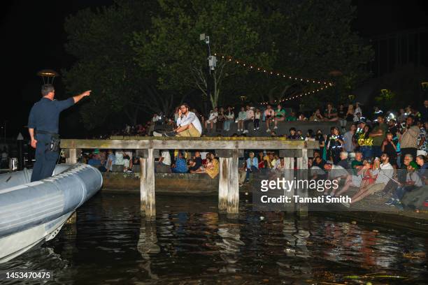 Two men are escorted off a dilapidated jetty by police on December 31, 2022 in Melbourne, Australia. Revelers turned out in droves to celebrate the...