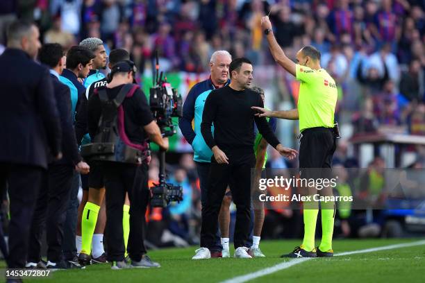 Xavi, Head Coach of FC Barcelona, receives a yellow card from Referee Antonio Mateu Lahoz during the LaLiga Santander match between FC Barcelona and...