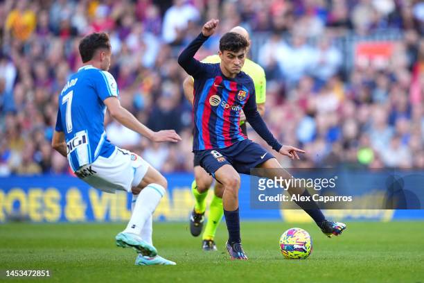 Pedri of FC Barcelona runs with the ball whilst under pressure from Javi Puado of RCD Espanyol during the LaLiga Santander match between FC Barcelona...