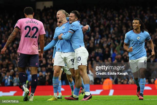 Erling Haaland of Manchester City celebrates with teammates after scoring the team's first goal during the Premier League match between Manchester...