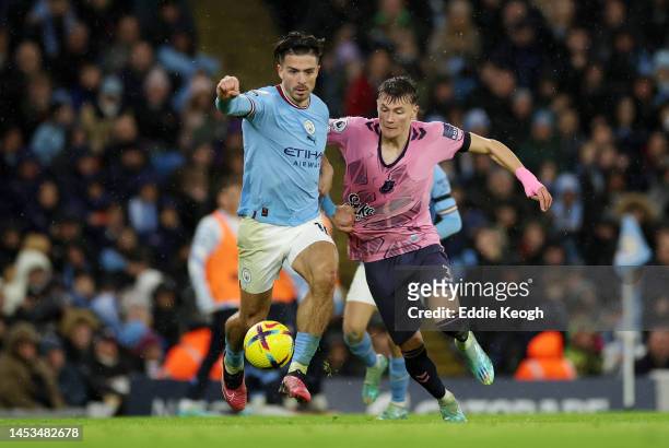 Jack Grealish of Manchester City battles for possession with Nathan Patterson of Everton during the Premier League match between Manchester City and...