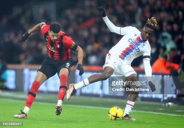 Wilfried Zaha of Crystal Palace is challenged by Dominic Solanke of AFC Bournemouth during the Premier League match between AFC Bournemouth and...