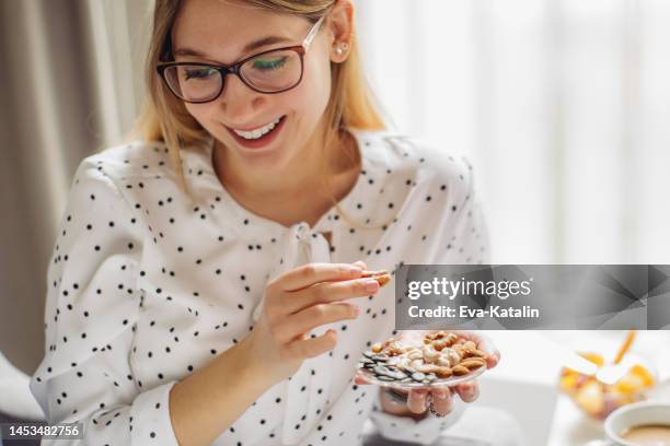 bon appétit! - eating nuts stock-fotos und bilder