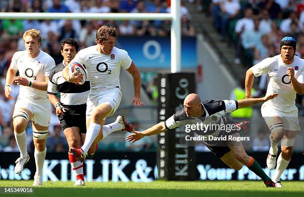 Alex Goode of England evades the tackle from Felipe Contepomi of The Barbarians during the Killik Cup match between England and The Barbarians at...