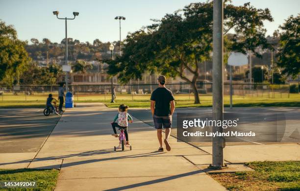 training wheels at park - torrance stock pictures, royalty-free photos & images