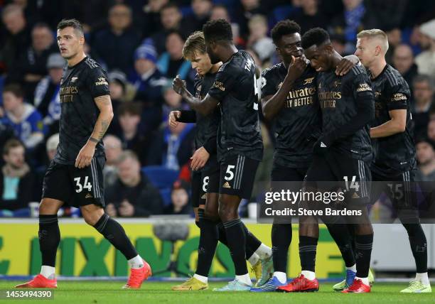 Martin Odegaard of Arsenal celebrates with teammates after scoring the team's second goal during the Premier League match between Brighton & Hove...